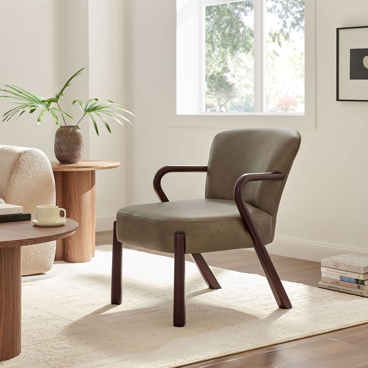 Mid-century accent chair elevates the room with mushroom faux leather and softly curved arms || EEI-7529-MUS || front_angle_room