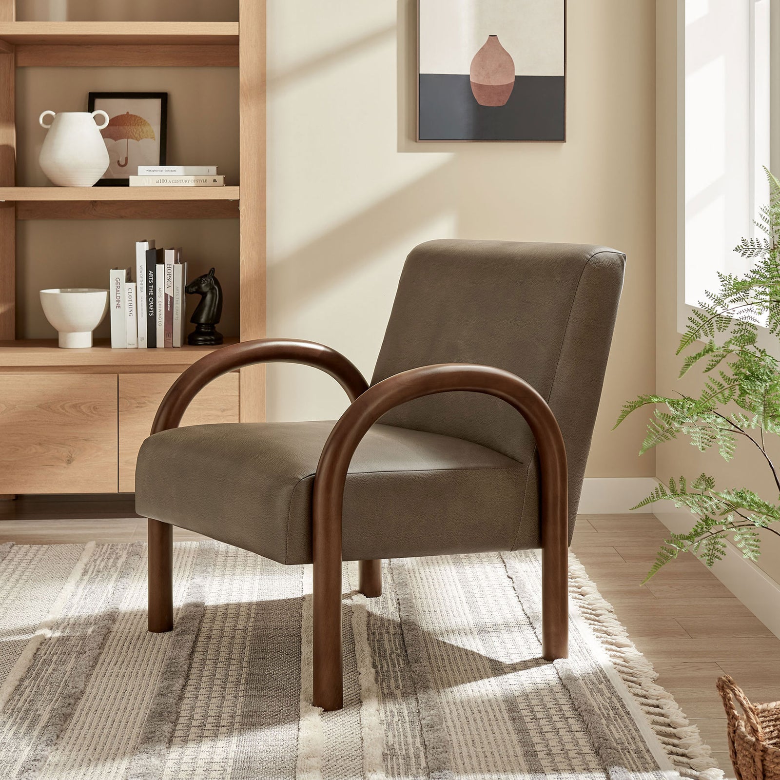 Statement accent chair anchors a cozy living space with mushroom faux leather and arched wood arms || EEI-7530-MUS || front_angle_room