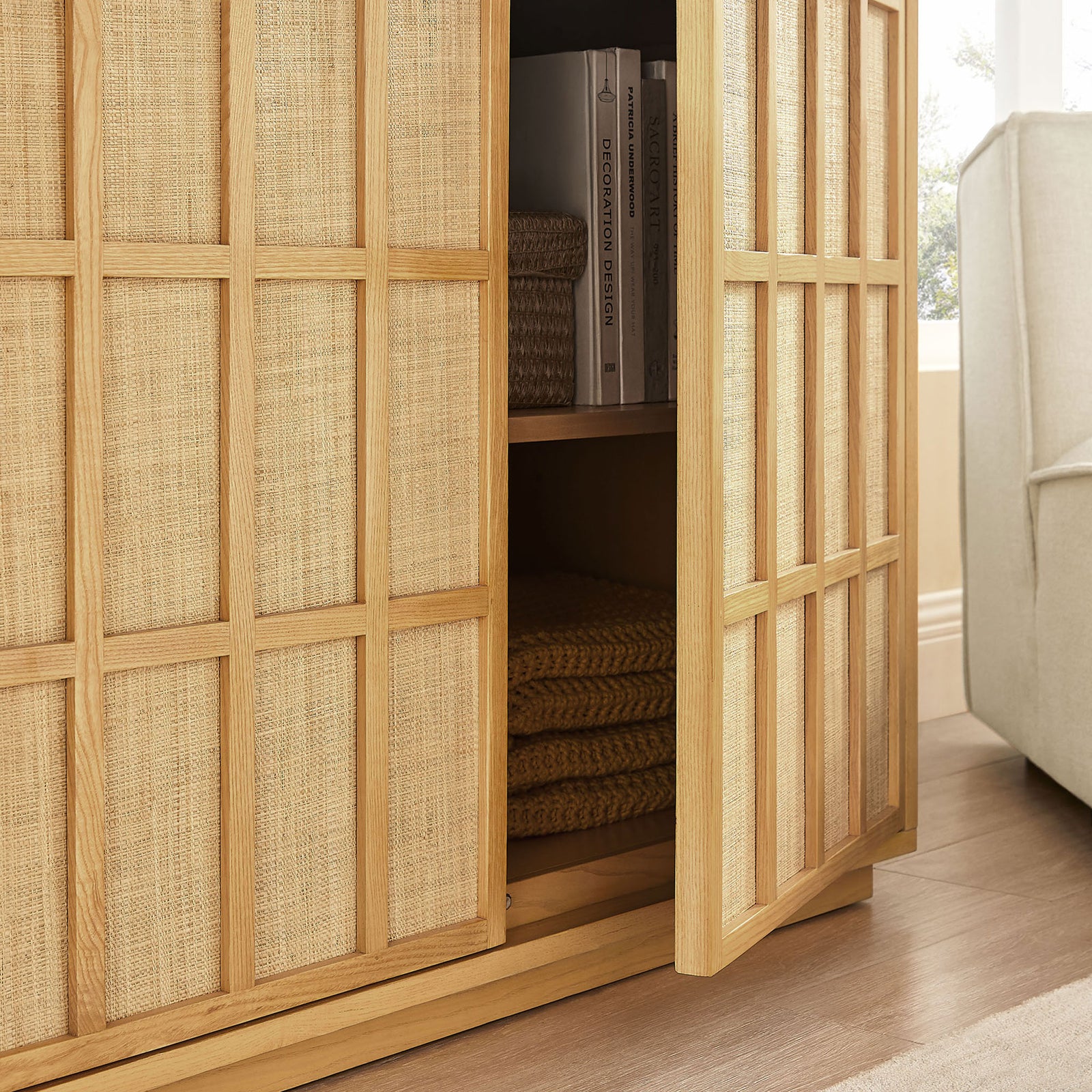 Cabinet doors glide open to reveal neatly organized shelves for throws, baskets, and books || EEI-7558-LOA || storage_open_room