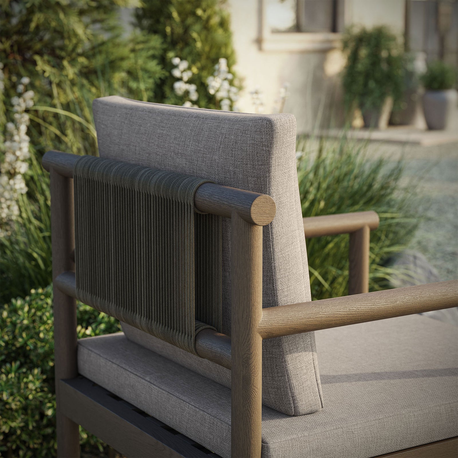 Close view of rope-wrapped gray backrest and light cushion set against an outdoor garden. || EEI-7561-WGR-PEB || detail_room