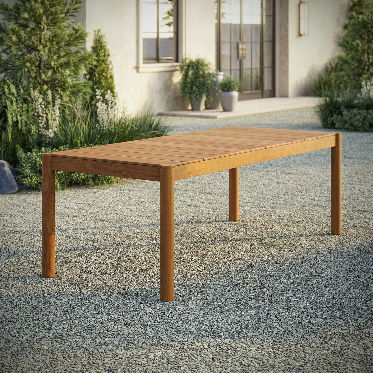 Eleni 89 inch natural teak outdoor dining table styled on a spacious patio ready for open air meals || EEI-7562-NAT || front_angle_room