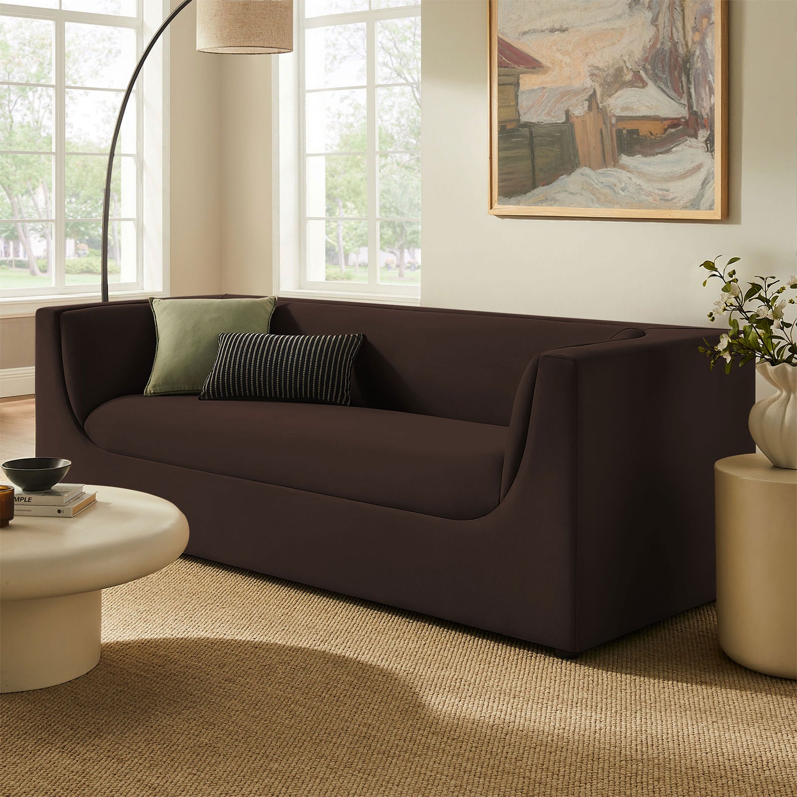 Hilda chocolate brown velvet sofa styled in a bright living room with neutral decor and plush pillows. || EEI-7564-CHB || front_angle_room