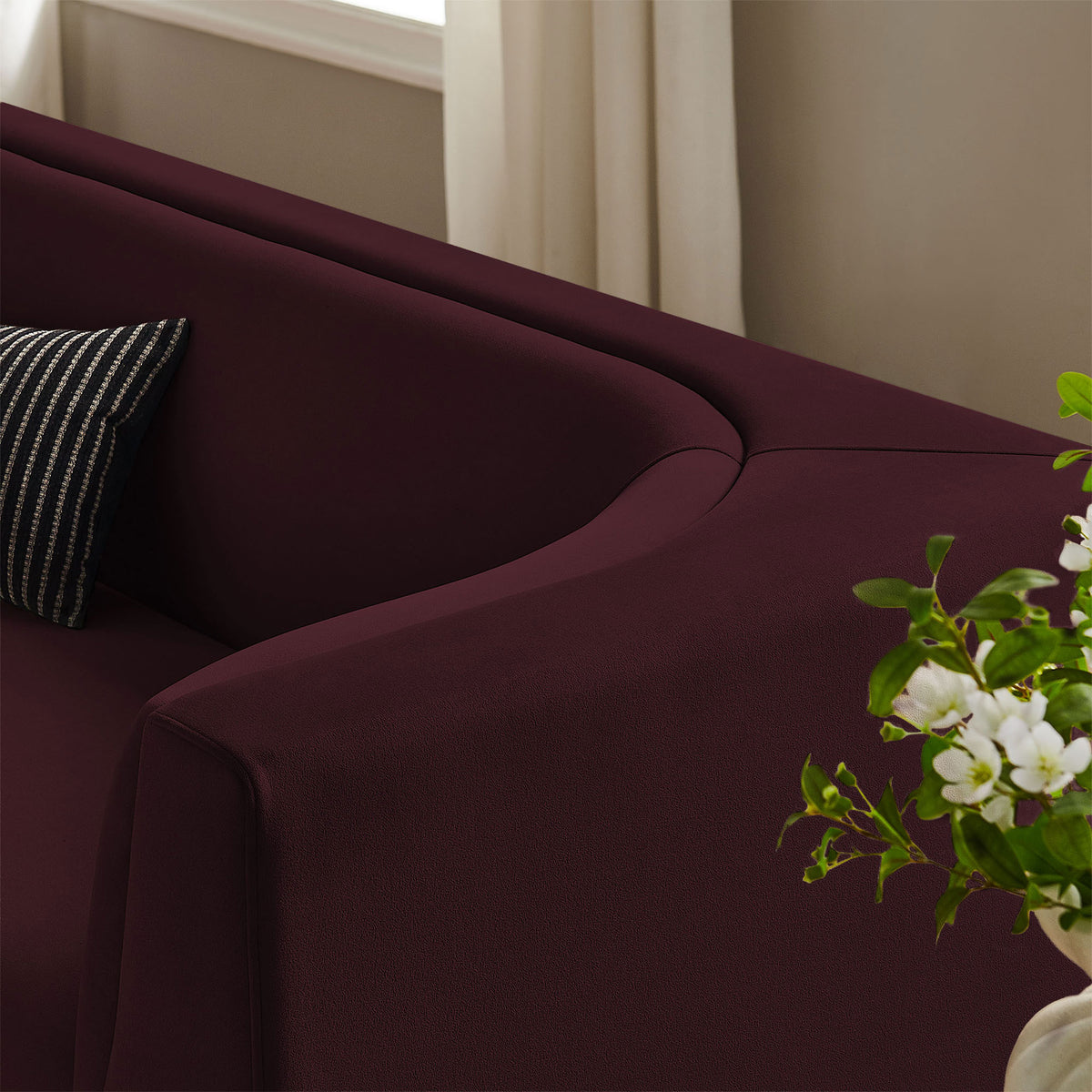 Hilda mulberry velvet sofa styled with greenery, emphasizing the soft curves and rich, smooth texture || EEI-7564-MUL || detail_room