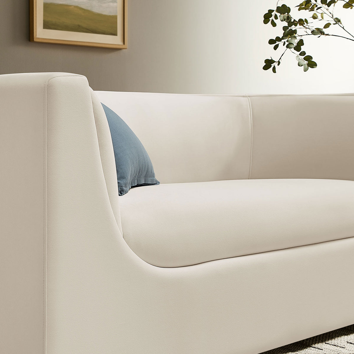 Hilda loveseat styled in a modern living room with alabaster velvet and a contrasting blue accent pillow || EEI-7565-ALA || detail_room
