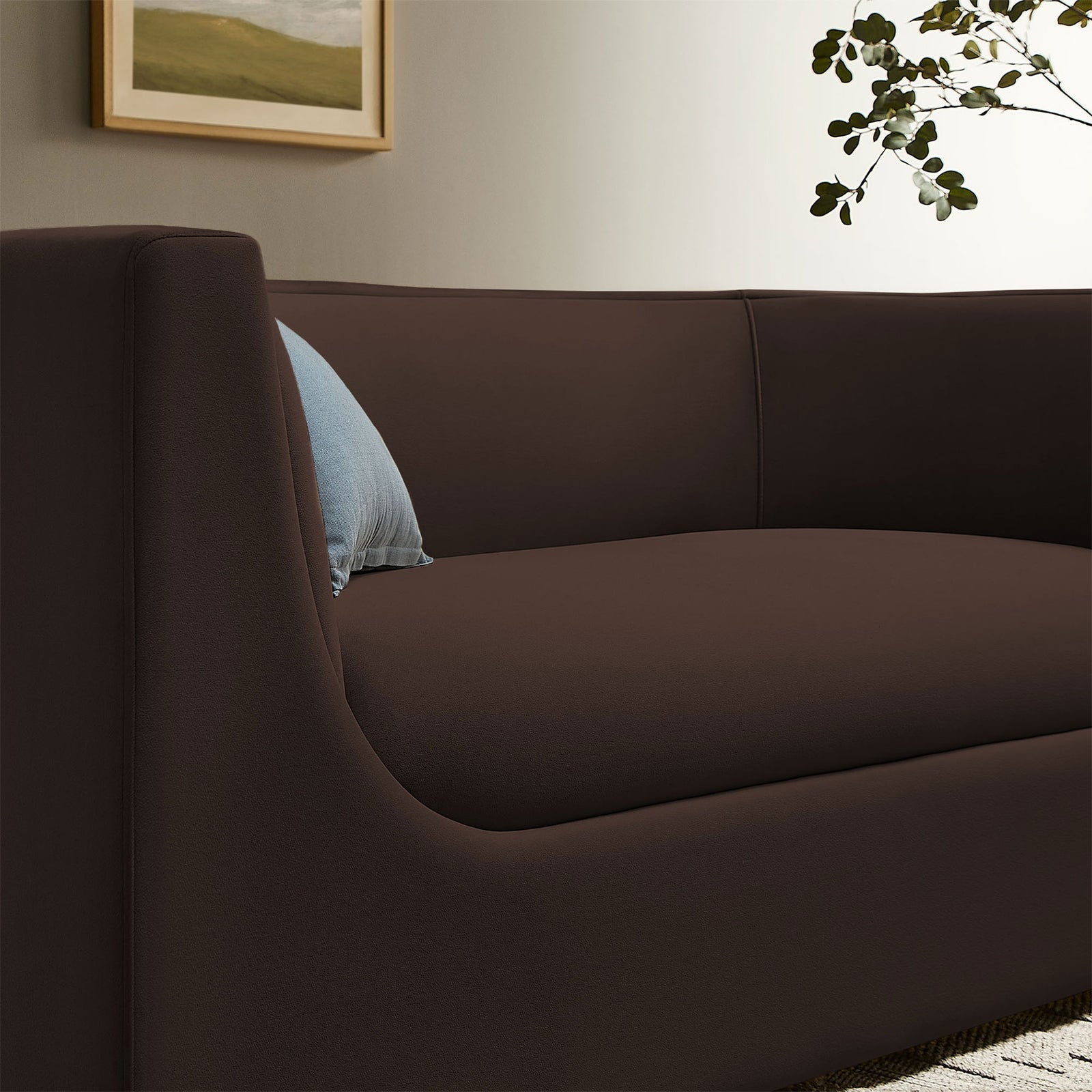 Chocolate brown velvet loveseat styled with a blue accent pillow in a warm contemporary living room || EEI-7565-CHB || detail_room