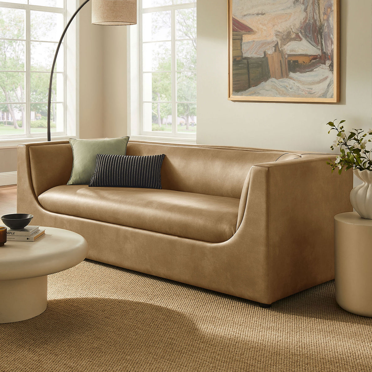 Toast vegan leather sofa anchors a modern living room with soft curves and low-profile comfort || EEI-7567-TST || front_angle_room