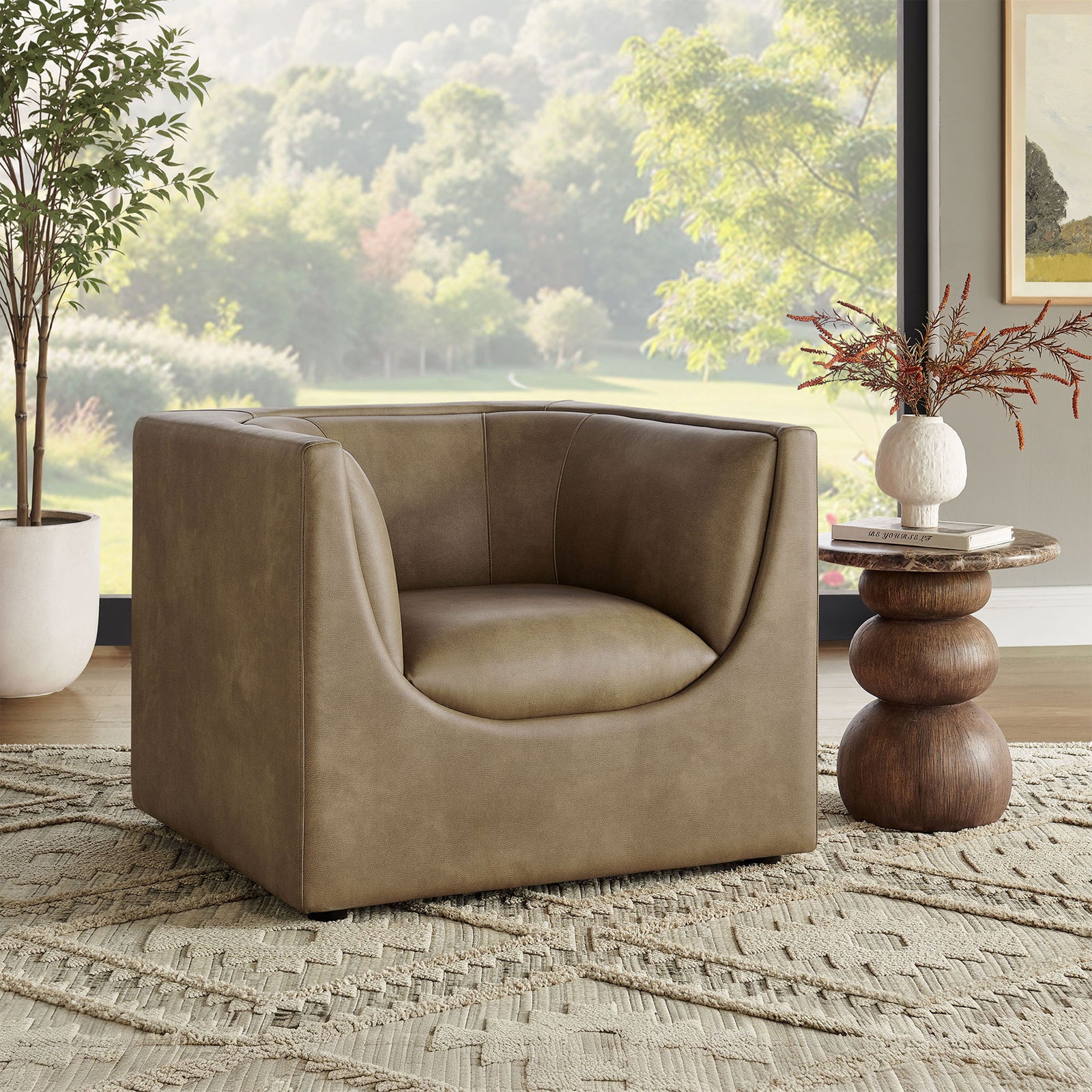 Mushroom vegan leather warms the room with a sculptural seat and curved arms for inviting lounge comfort. || EEI-7569-MUS || front_angle_room