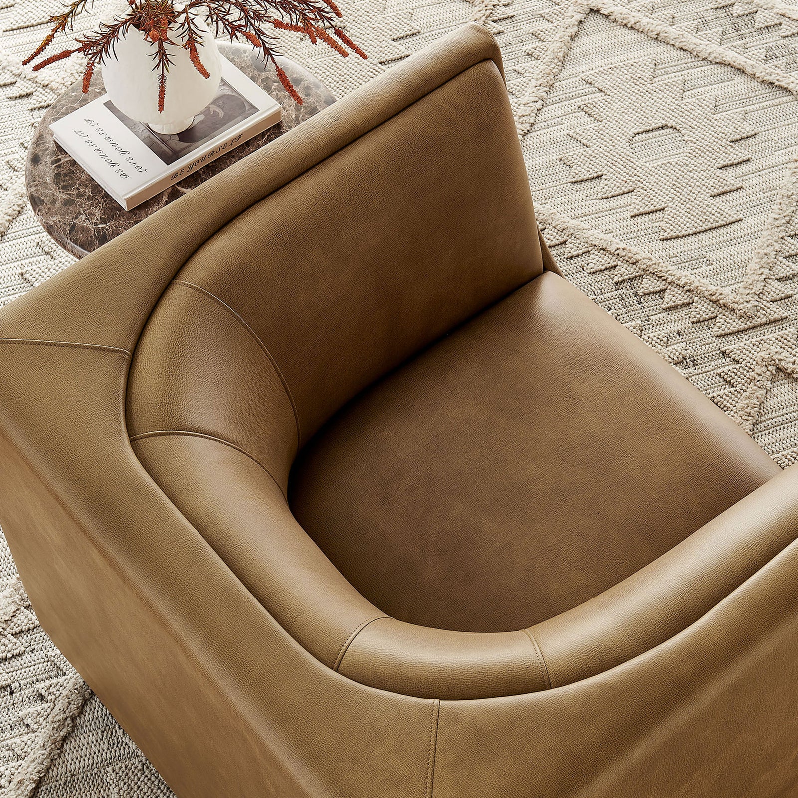 Textured vegan leather and refined stitching elevate the lounge-ready seat in warm toast || EEI-7569-TST || detail_room