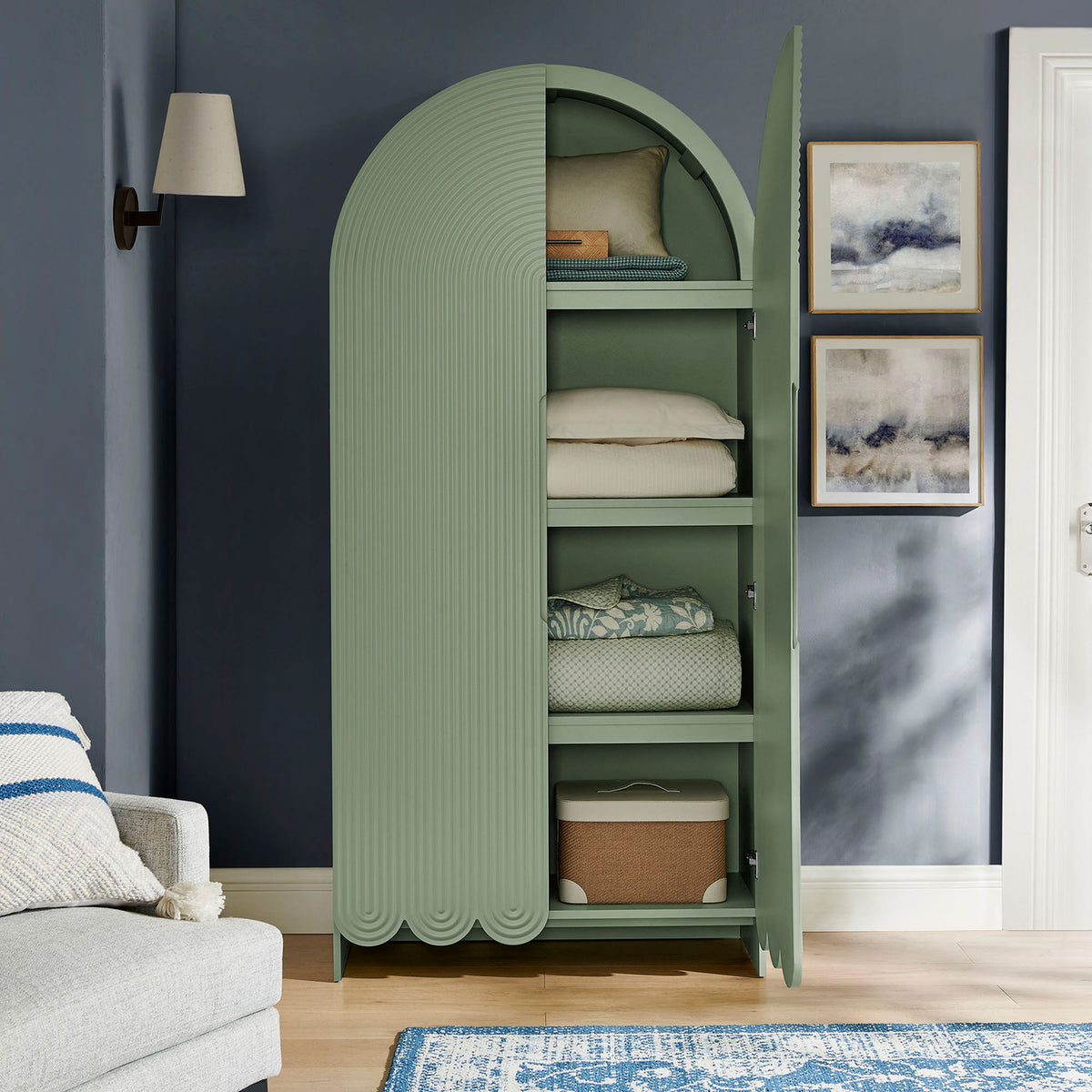Sage green arched cabinet with open doors organized with folded blankets and baskets || EEI-7570-SGE || front_open_room