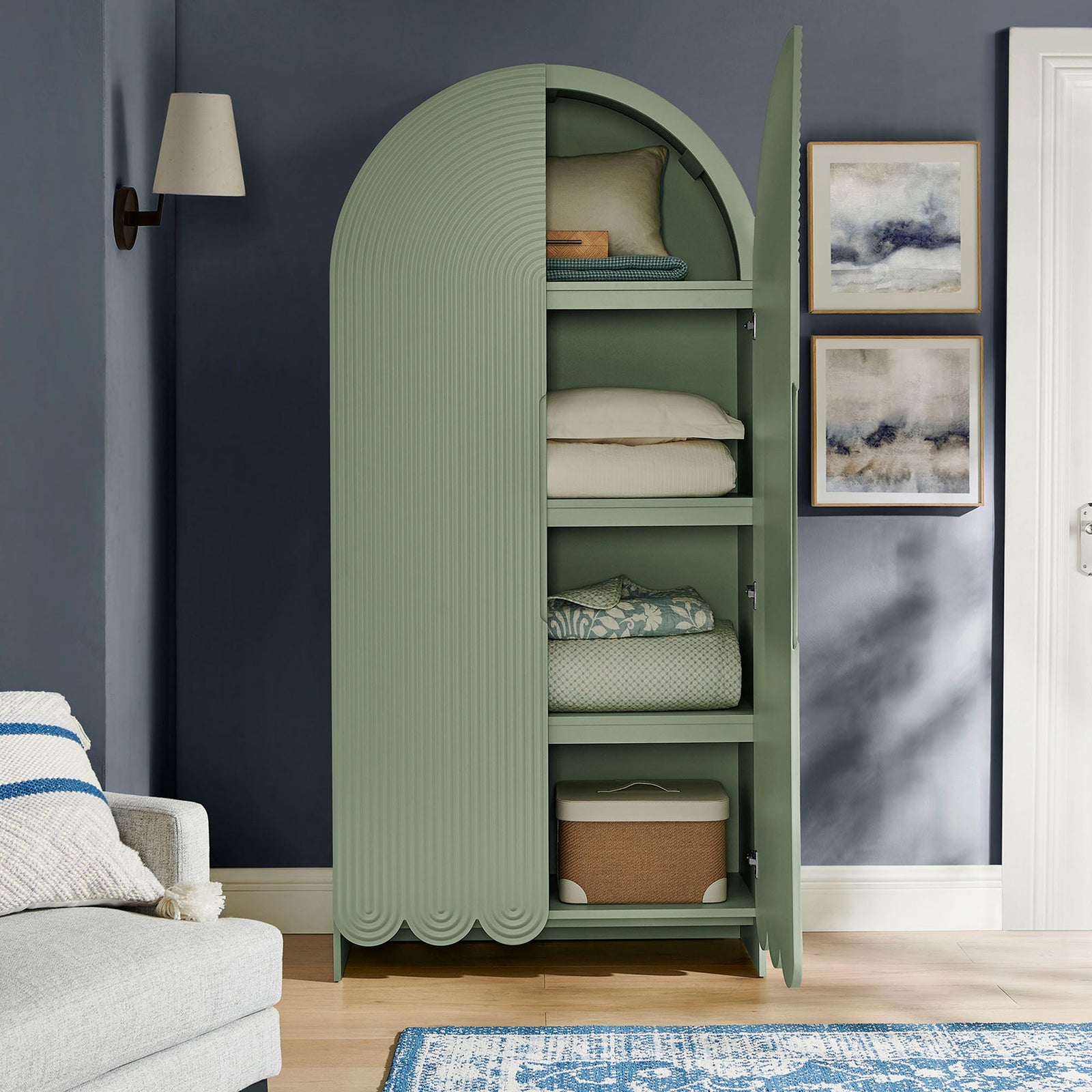 Sage green arched cabinet with open doors organized with folded blankets and baskets || EEI-7570-SGE || front_open_room