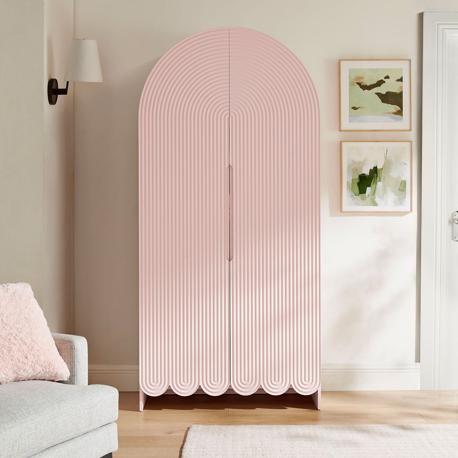 Soft pink arched storage cabinet adding playful sculptural texture to a bright living space || EEI-7570-SPN || front_room