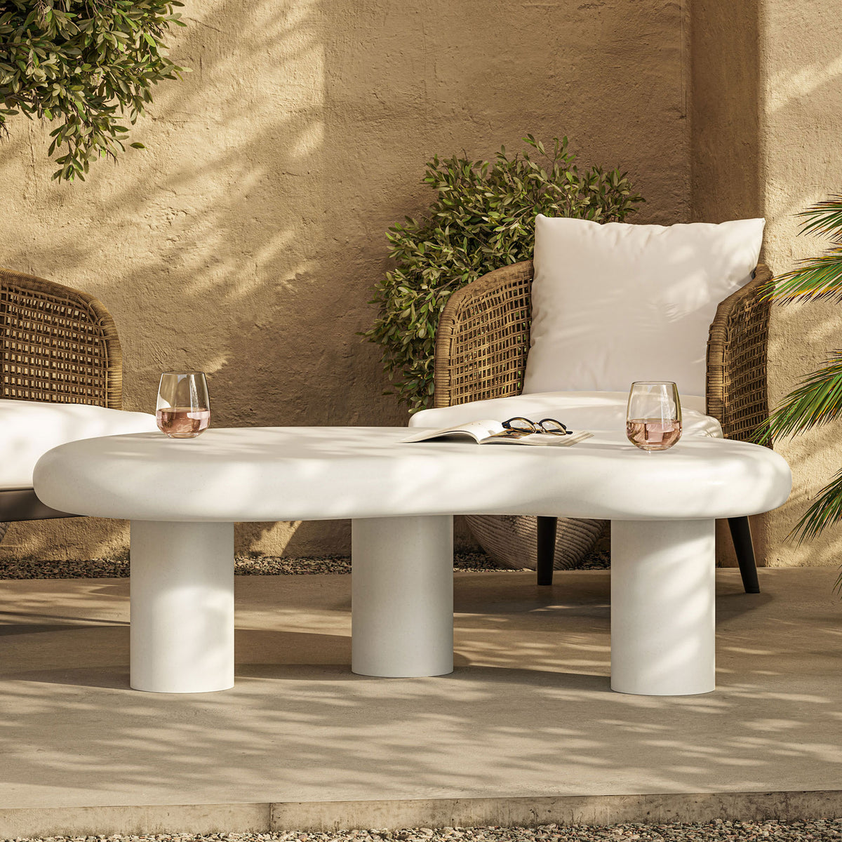Modern white concrete coffee table defines a cozy patio scene with woven chairs and evening drinks || EEI-7571-WHI || front_room