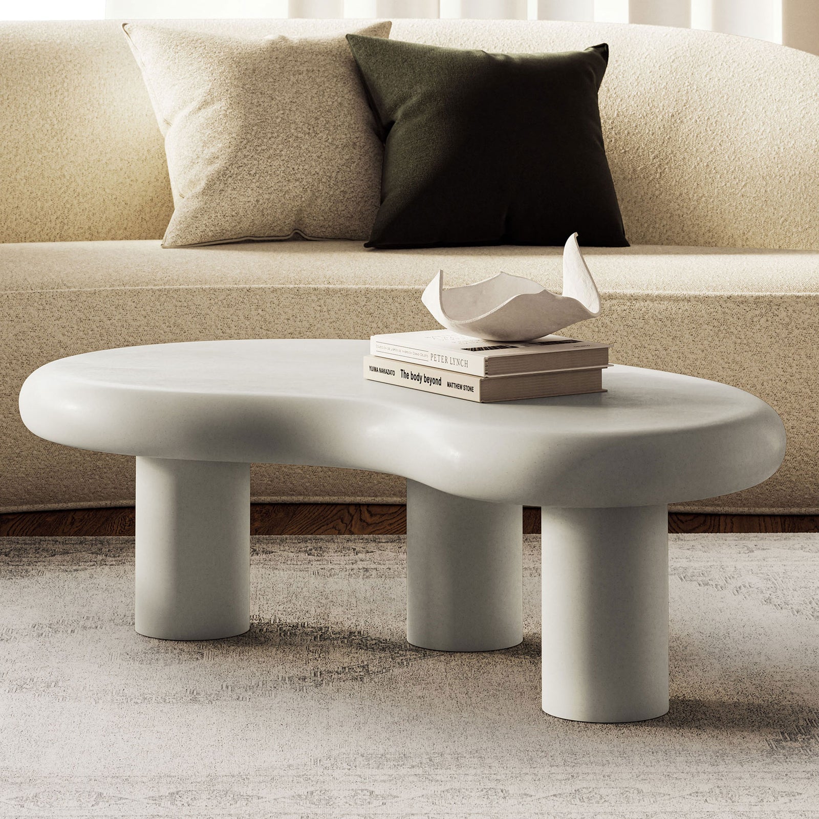 Elowen white concrete coffee table anchors a layered living room, pairing organic curves with plush seating || EEI-7571-WHI || front_angle_room