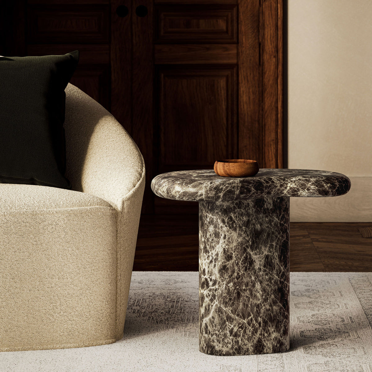 Dark faux marble side table styled in a warm living room beside a textured armchair and neutral rug || EEI-7572-EMP || front_angle_room