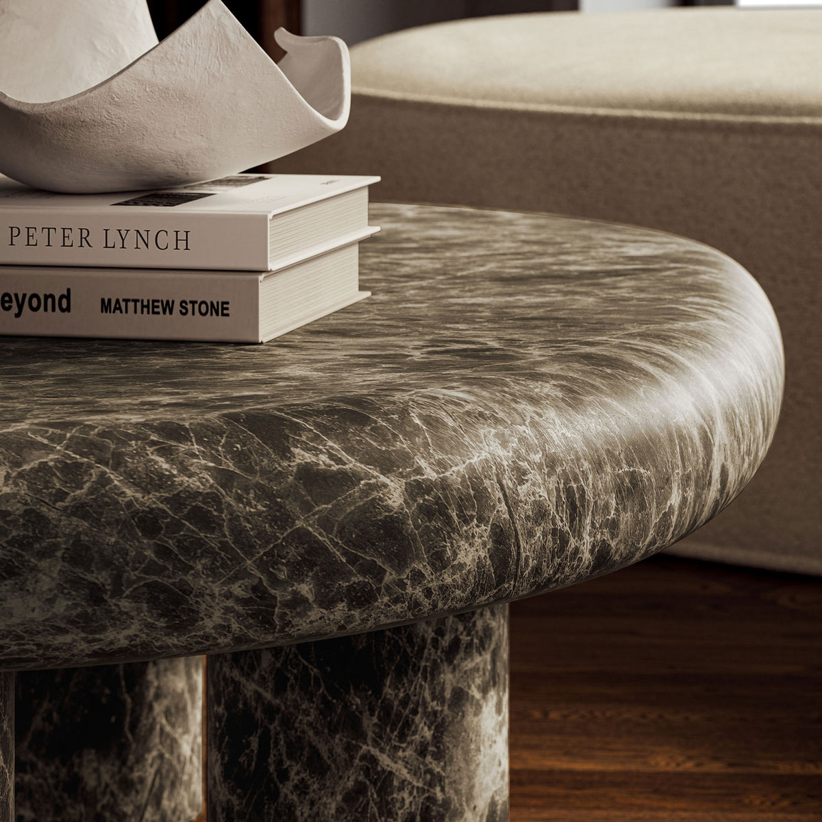 Faux emperador marble surface pairs with sculptural legs to add rich texture beside a modern sofa || EEI-7573-EMP || detail_room