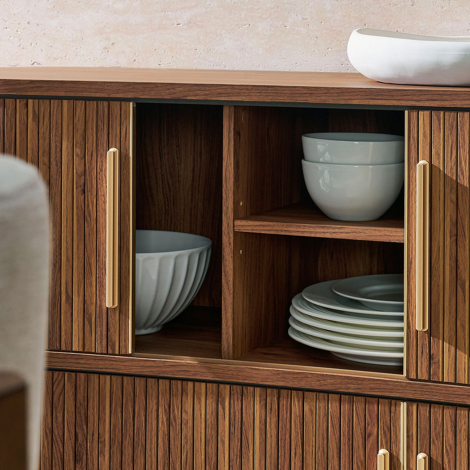 Interior shelves neatly house dishes, showing practical storage space behind the cabinet's curved fluted doors || EEI-7583-WAL || storage_open_room