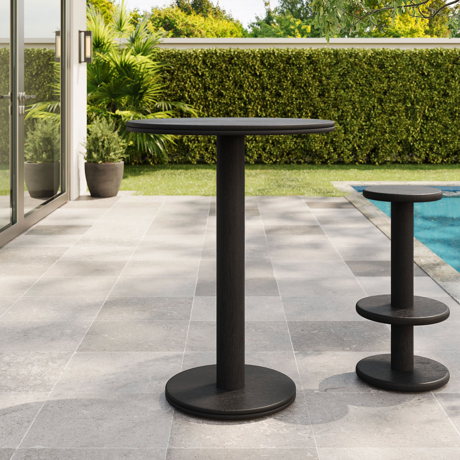 Black acacia bar table on patio with matching pedestal stool, perfect for casual poolside gatherings. || EEI-7585-BLK || front_angle_room