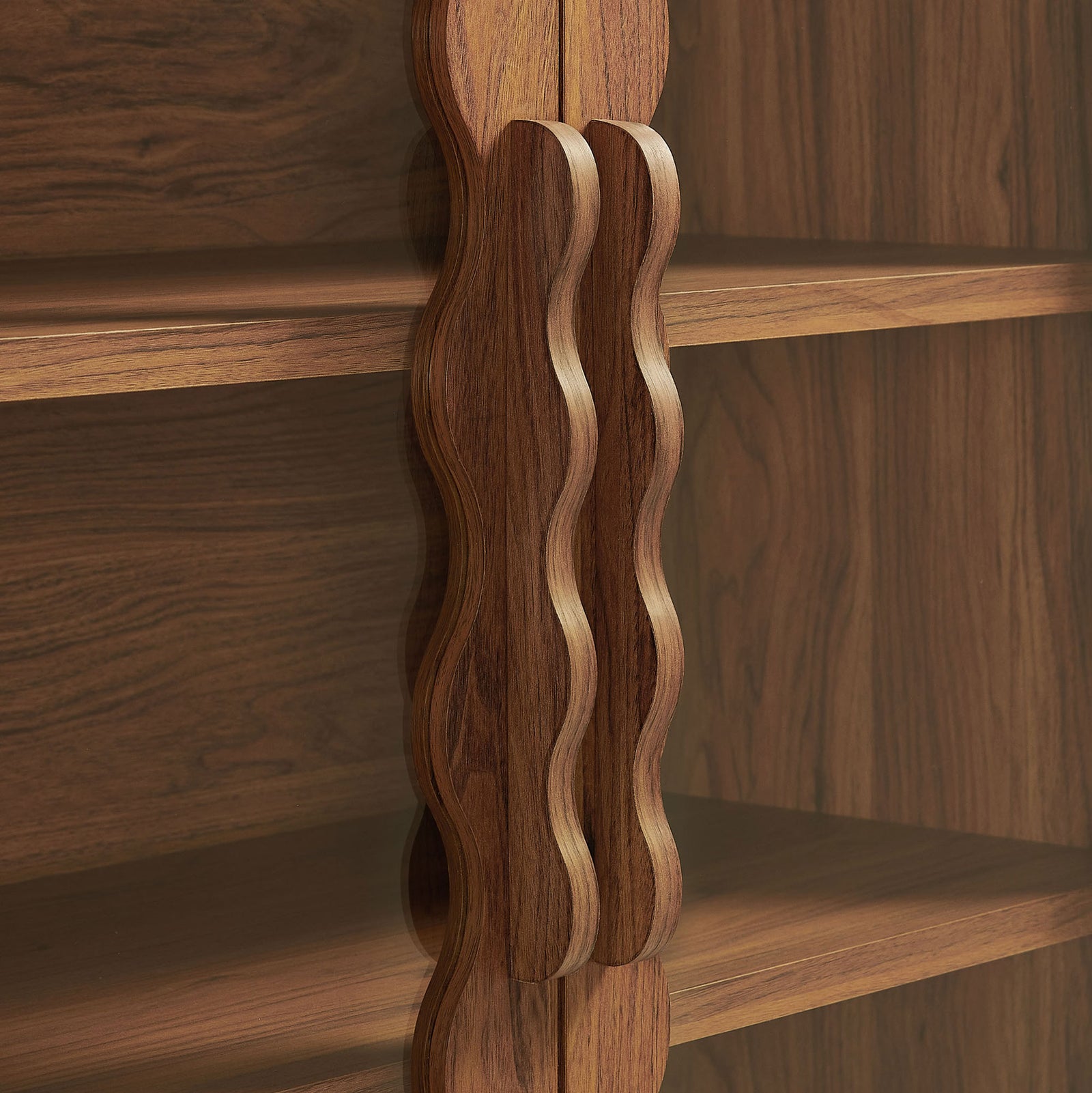 Sculpted wavy cabinet handles in a coordinating walnut wood finish || EEI-7589-WAL || handle_studio