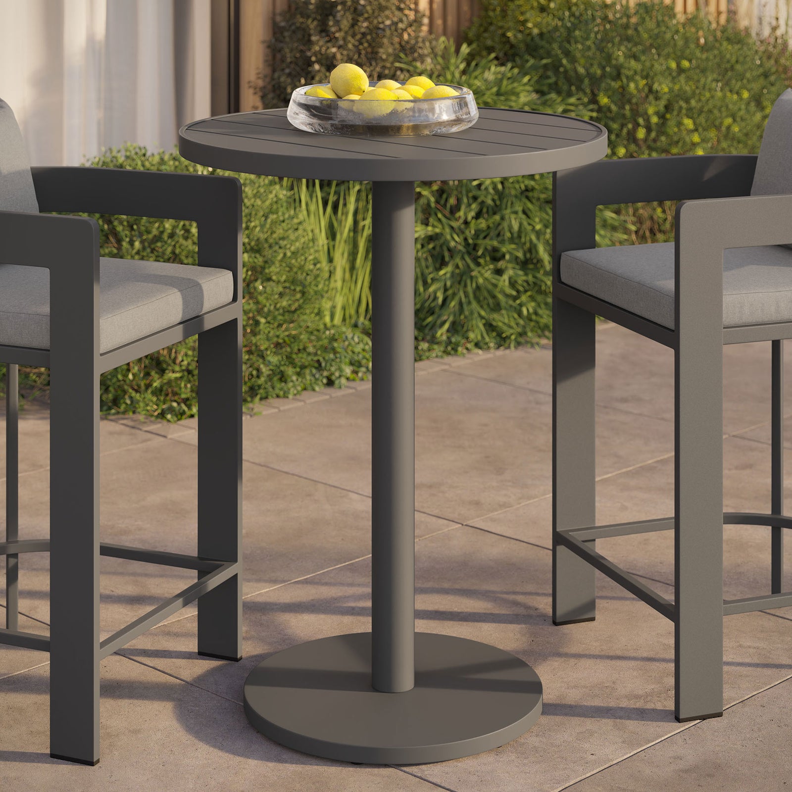 Gray round aluminum bar table on outdoor patio paired with coordinating bar stools for casual dining || EEI-7594-GRY || front_angle_room