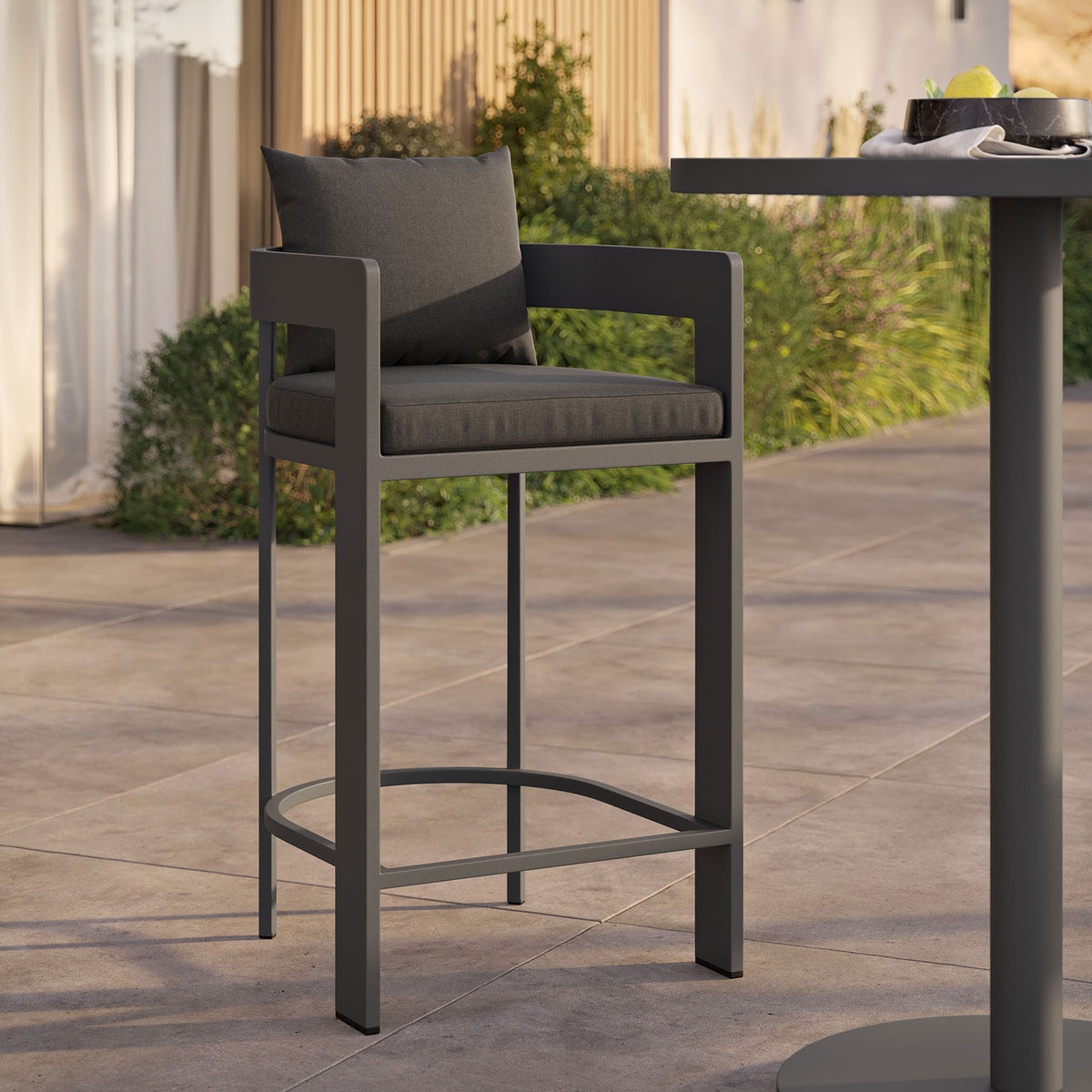 Tahoe bar chair styled by a modern outdoor bar table for relaxed poolside gathering spaces. || EEI-7595-CHA || front_angle_room