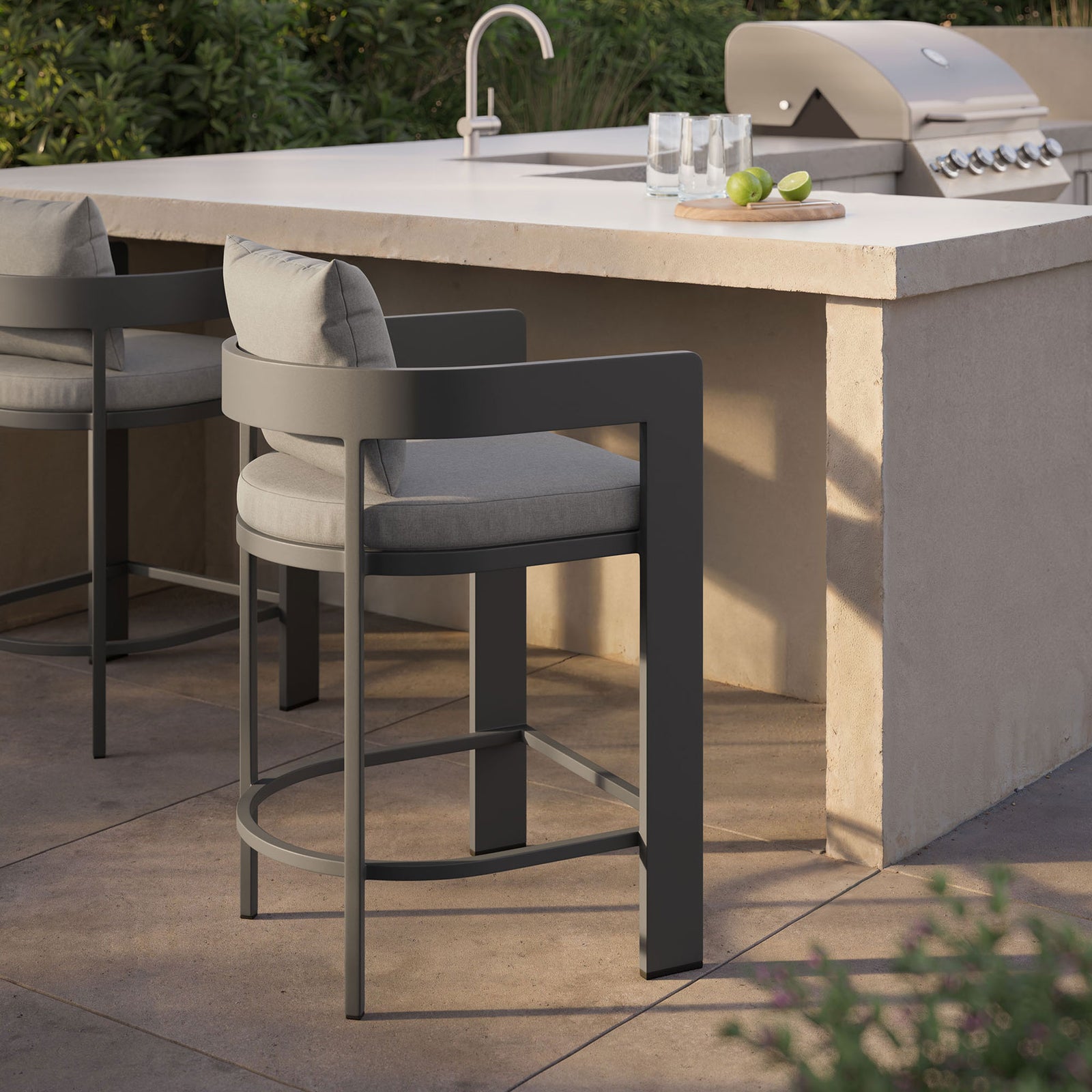 Tahoe counter stool with gray cushions arranged at an outdoor bar for effortless poolside entertaining. || EEI-7596-GRY || front_angle_room