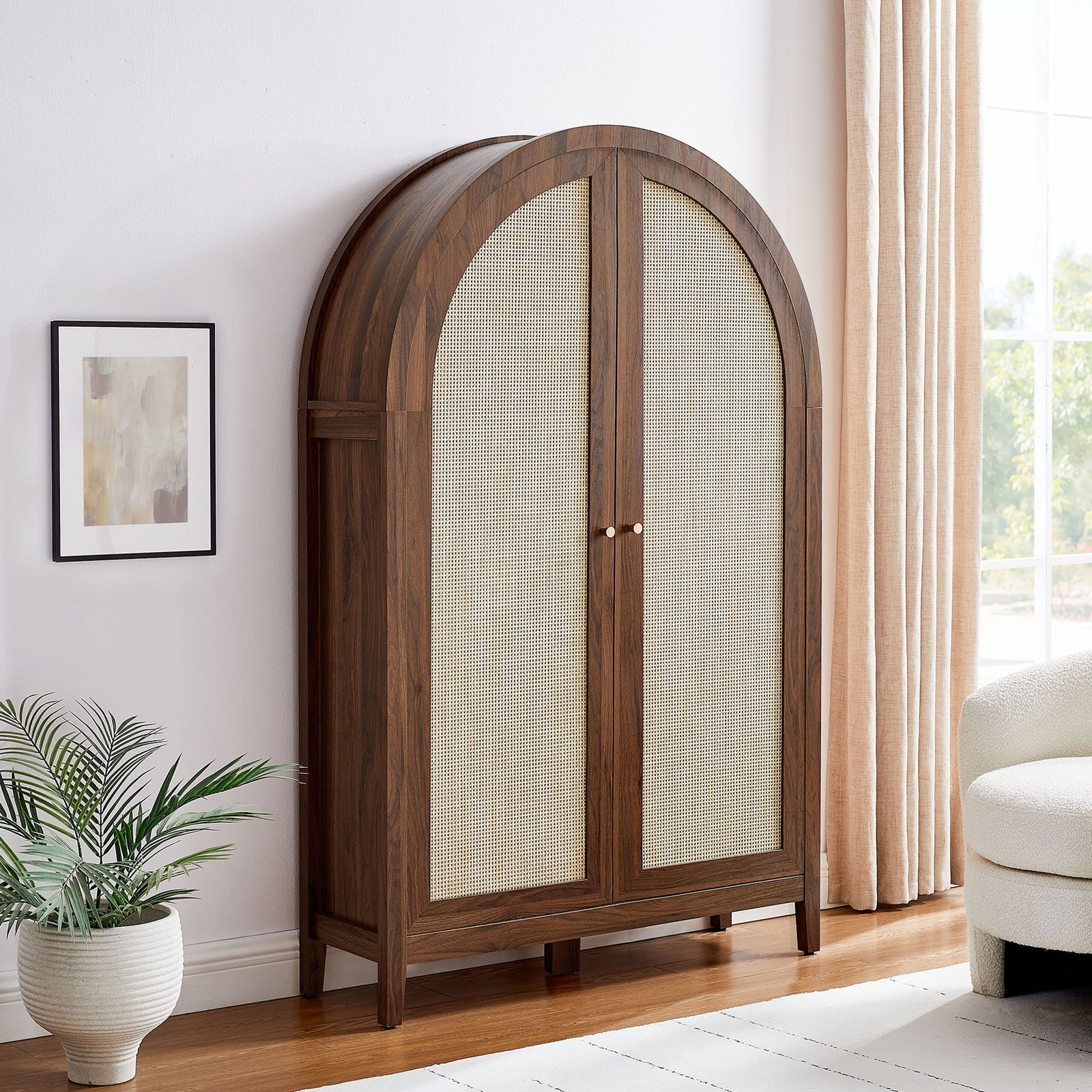 Elevated arched cabinet anchors the room with walnut grain and rattan texture for versatile storage || EEI-7604-WAL || front_angle_room