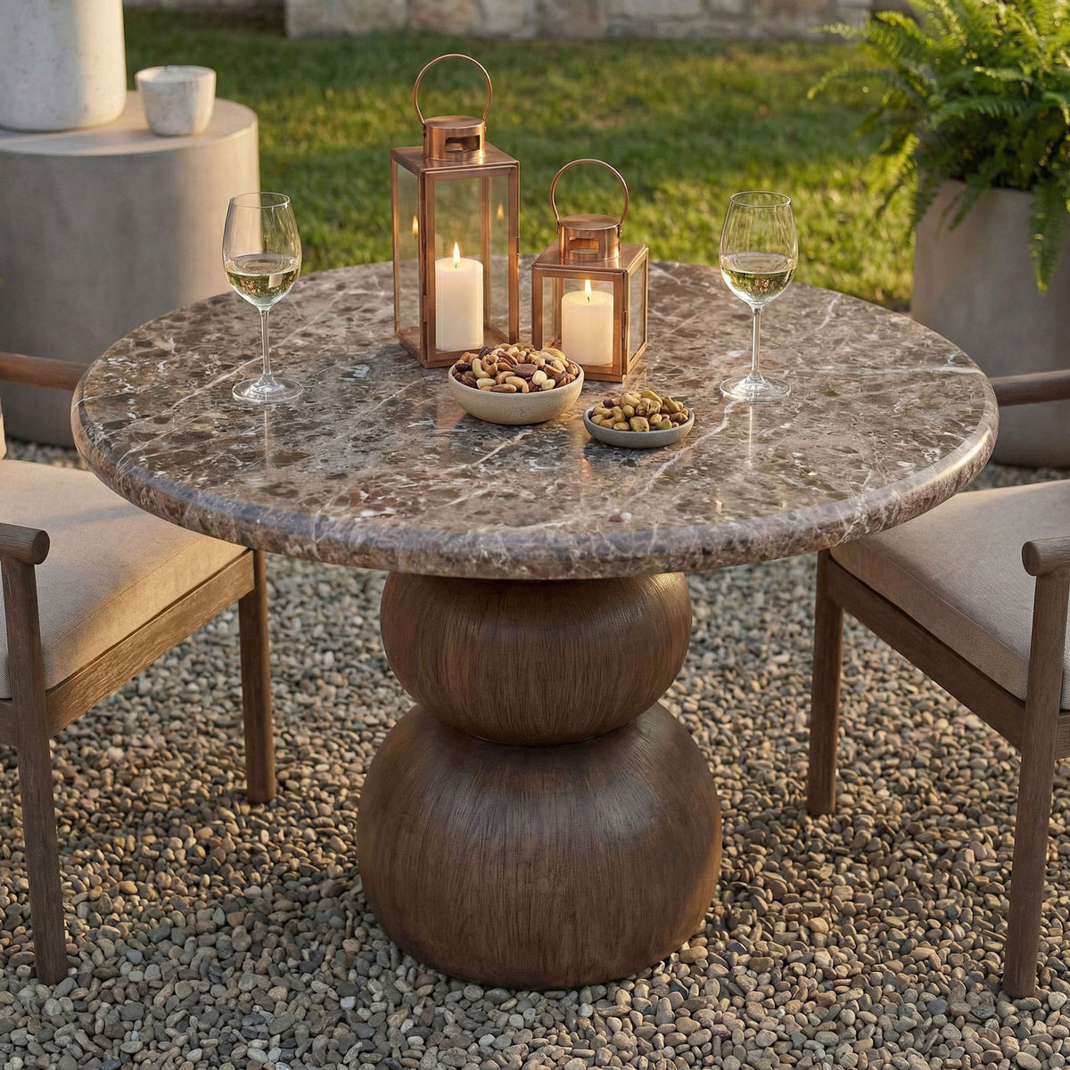 Outdoor round table styled with candles, snacks, and glassware on the dark marble-look top || EEI-7624-EMP || detail_room