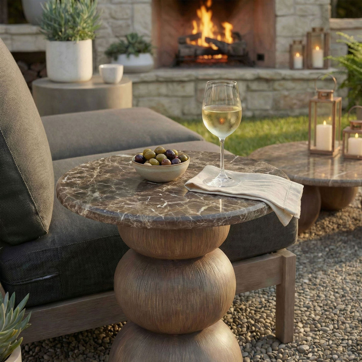 Round side table with marble-look top styled on a patio near a fire feature for elevated outdoor entertaining. || EEI-7625-EMP || front_angle_room