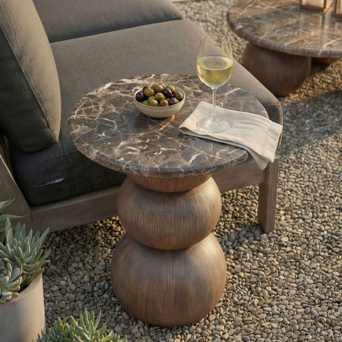 Compact marble-look side table next to a lounge chair, perfect for holding drinks and small bites outside. || EEI-7625-EMP || front_angle_room