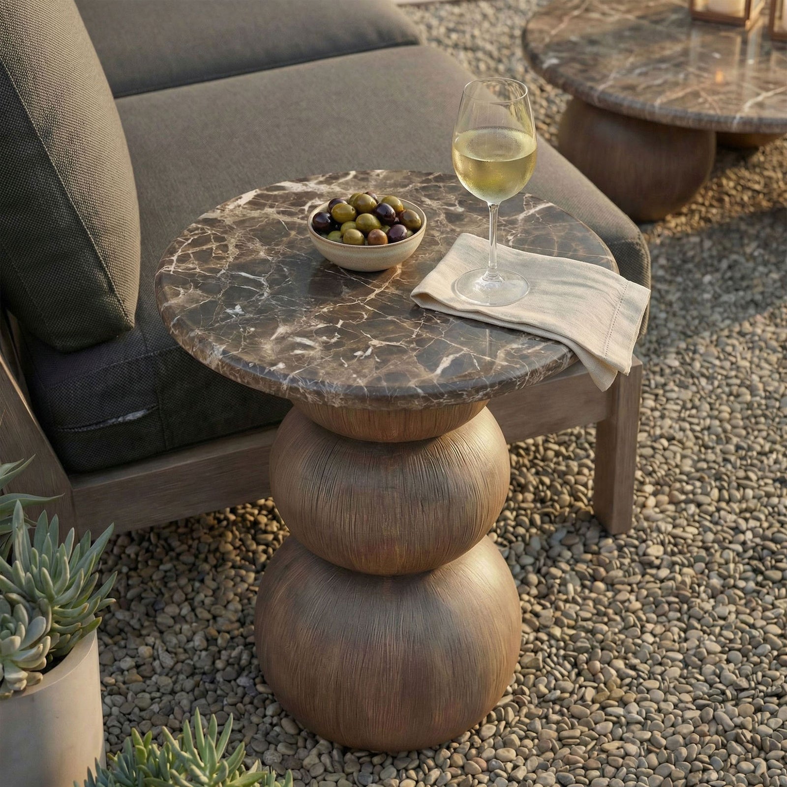 Compact marble-look side table next to a lounge chair, perfect for holding drinks and small bites outside. || EEI-7625-EMP || front_angle_room