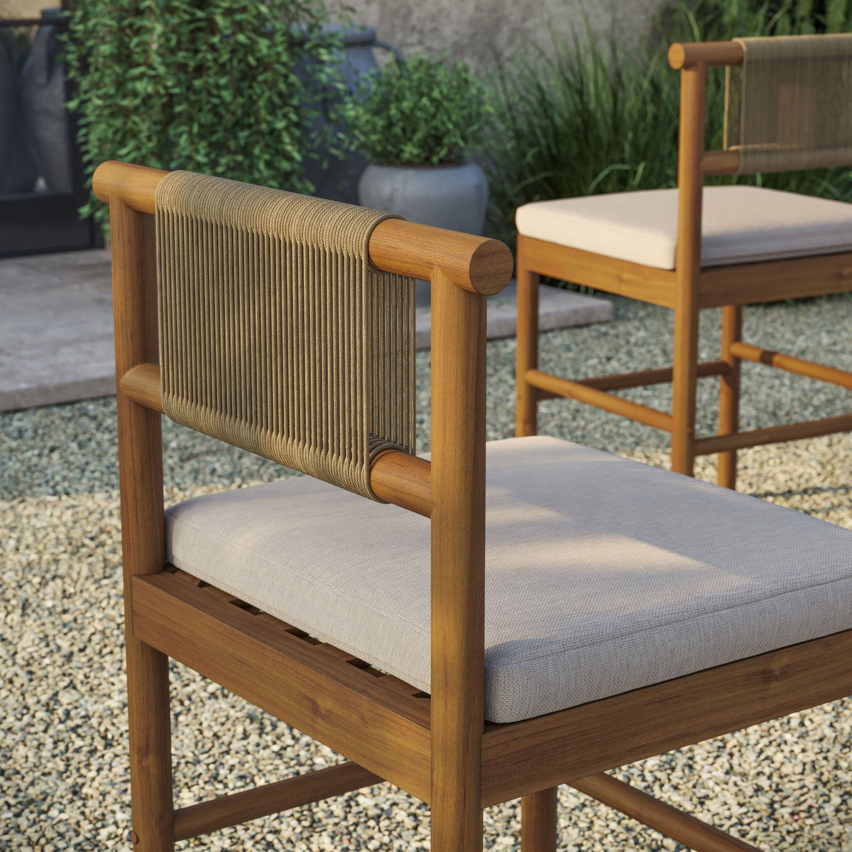 Outdoor detail of teak counter stool backrest with woven rope framed by lush greenery || EEI-7627-NAT-SAI || detail_room