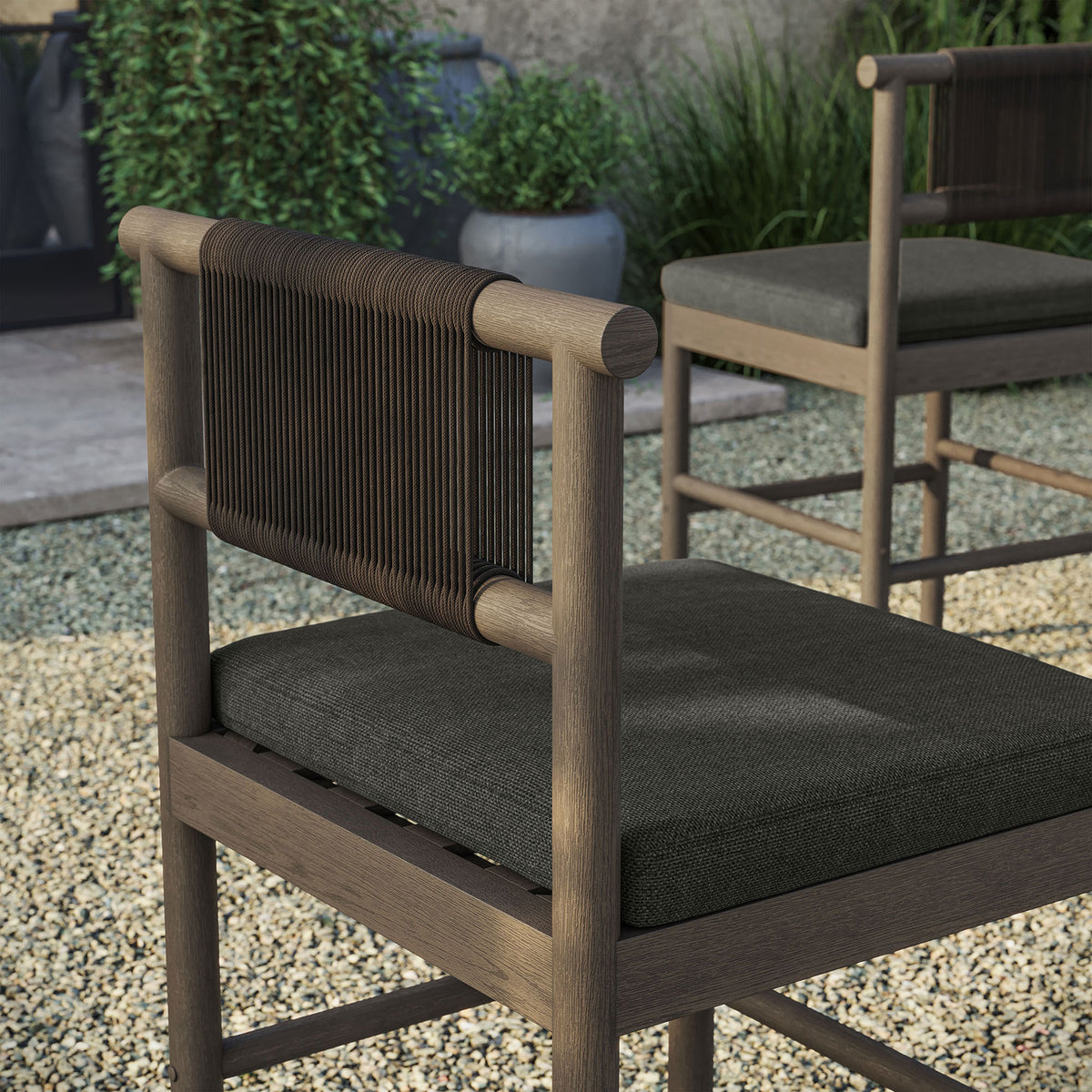 Outdoor detail of weathered gray counter stool rope back and cushion beside bar table || EEI-7627-WGR-FLI || detail_room