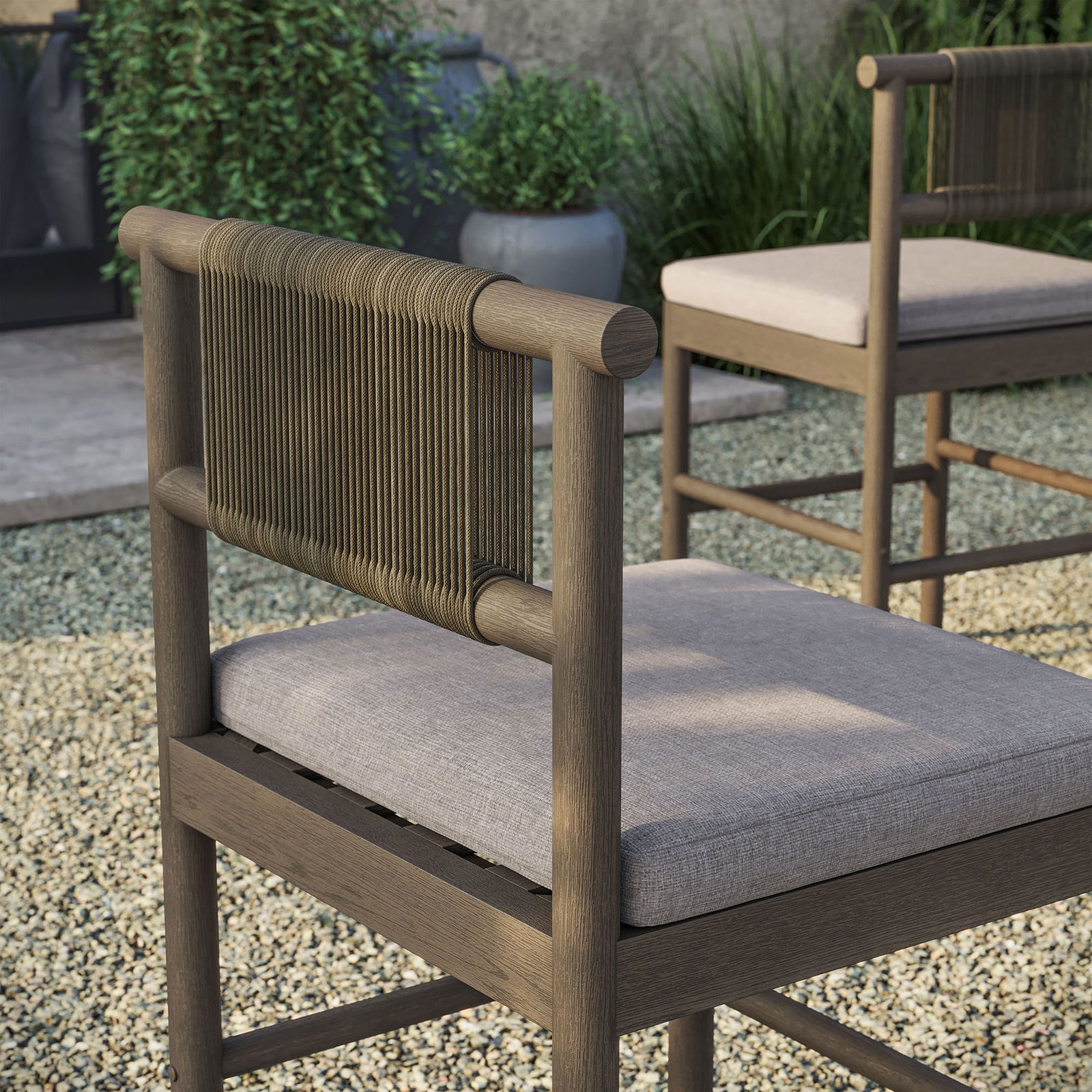 Outdoor detail of weathered gray counter stool rope back and pebble cushion beside bar table || EEI-7627-WGR-PEB || detail_room