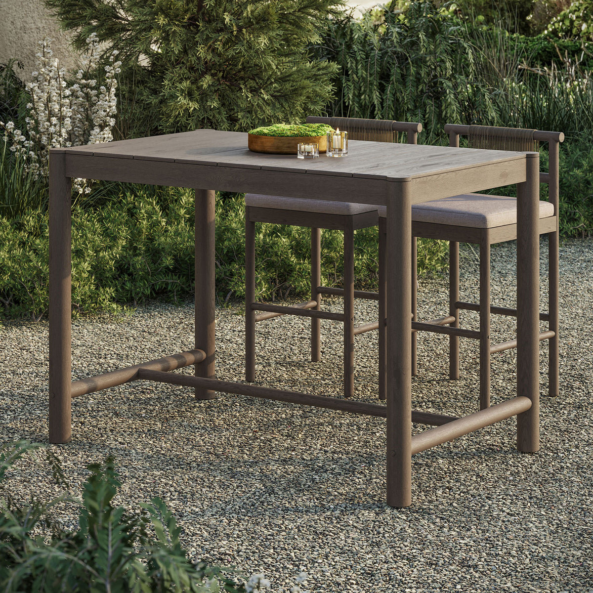 Weathered gray teak bar table anchors an intimate outdoor bar setting with matching stools || EEI-7629-WGR || front_angle_room