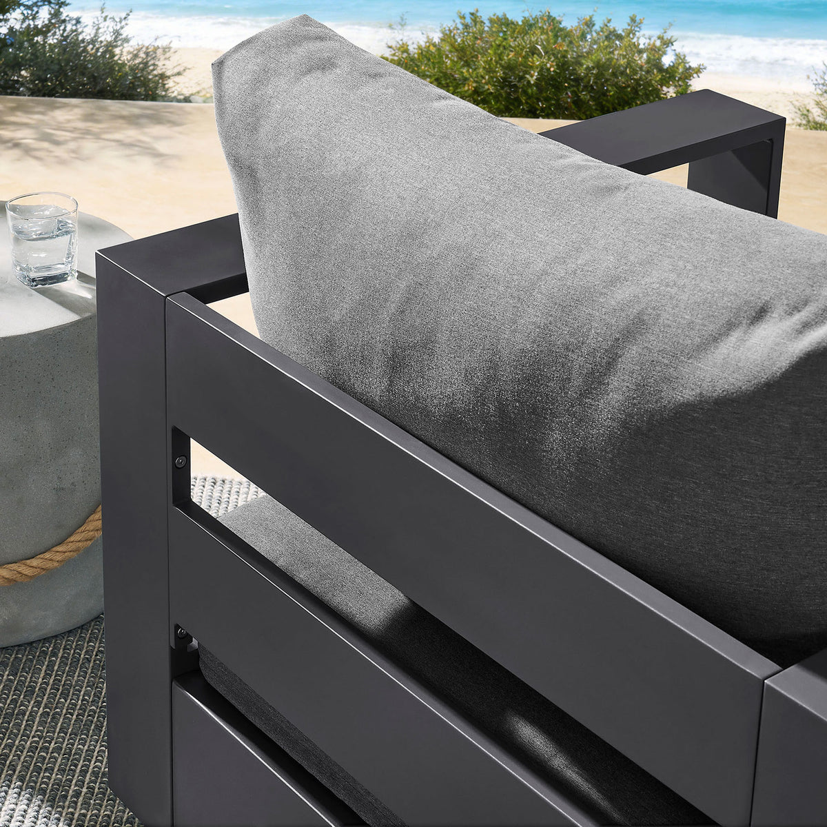 Outdoor detail of Tahoe armchair showing plush gray back cushion against charcoal slatted frame || EEI-7728-GRY-CHA || detail_room