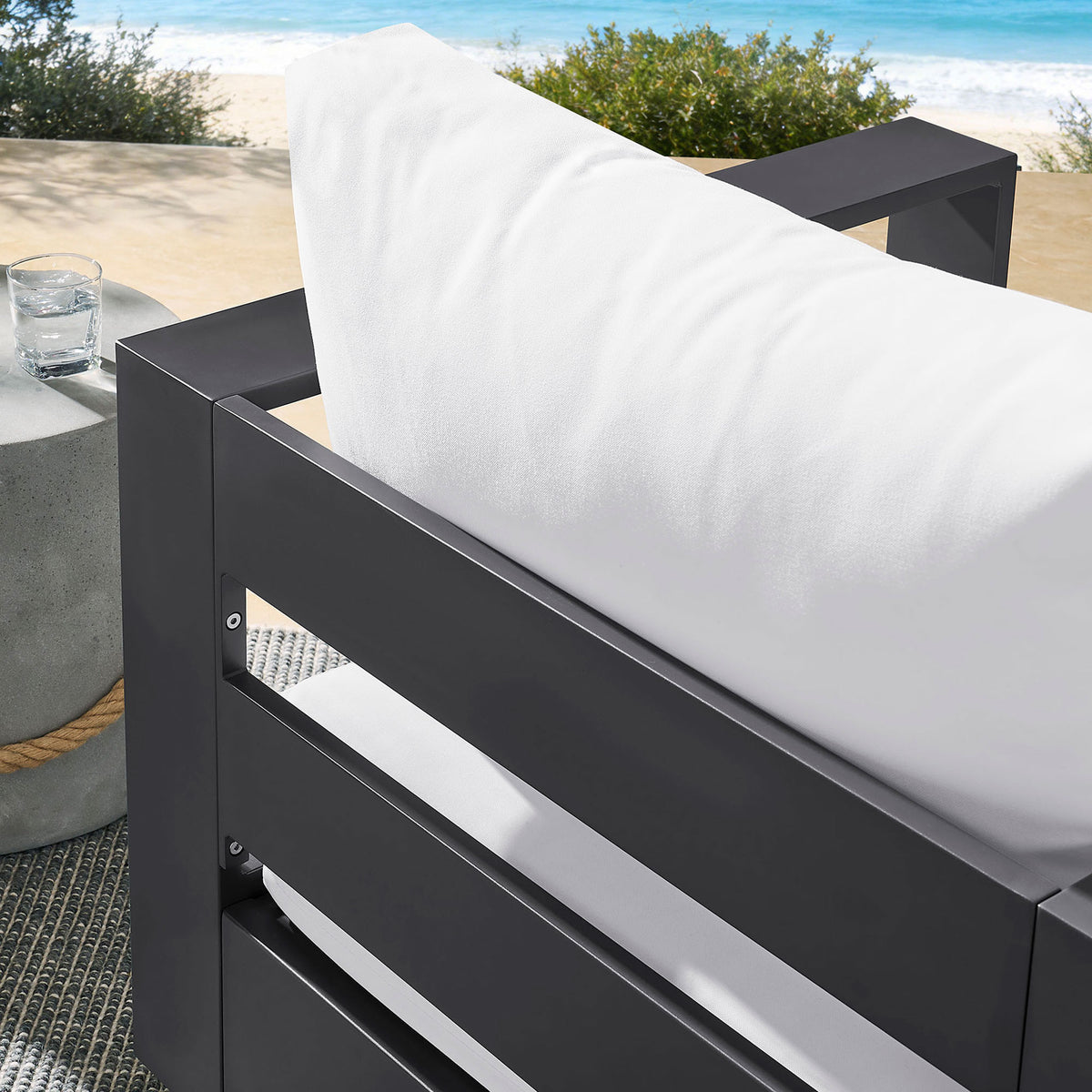 Outdoor detail of Tahoe chair revealing white back cushion resting against dark slatted frame || EEI-7728-GRY-WHI || detail_room
