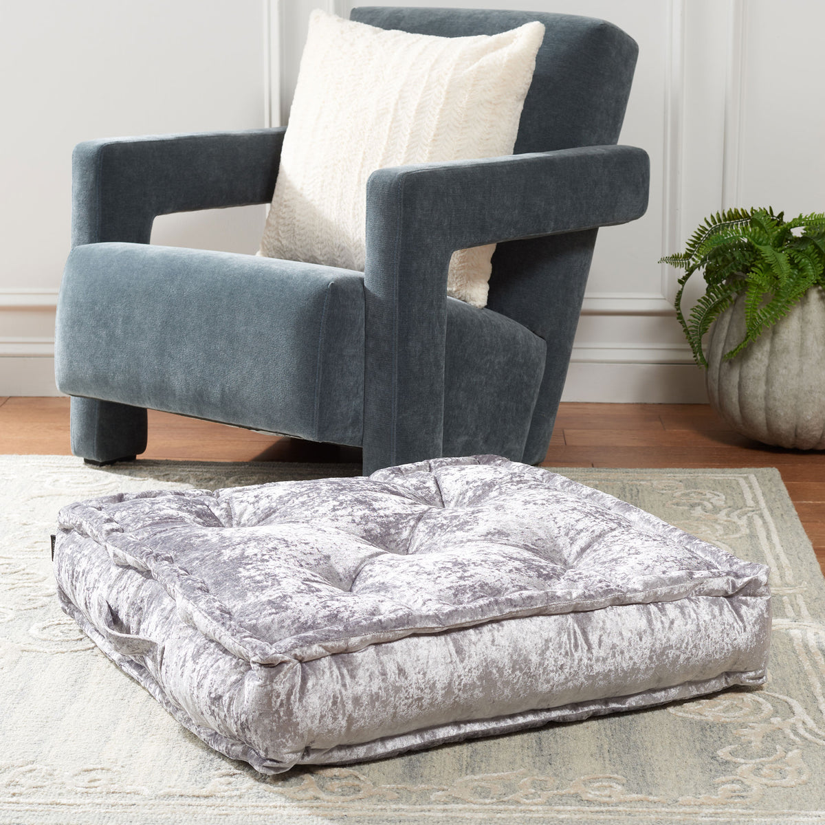 A soft silver floor pillow adds a tufted seat and gentle sheen to a relaxed space. || FLP1001G-1818 || front_angle_room