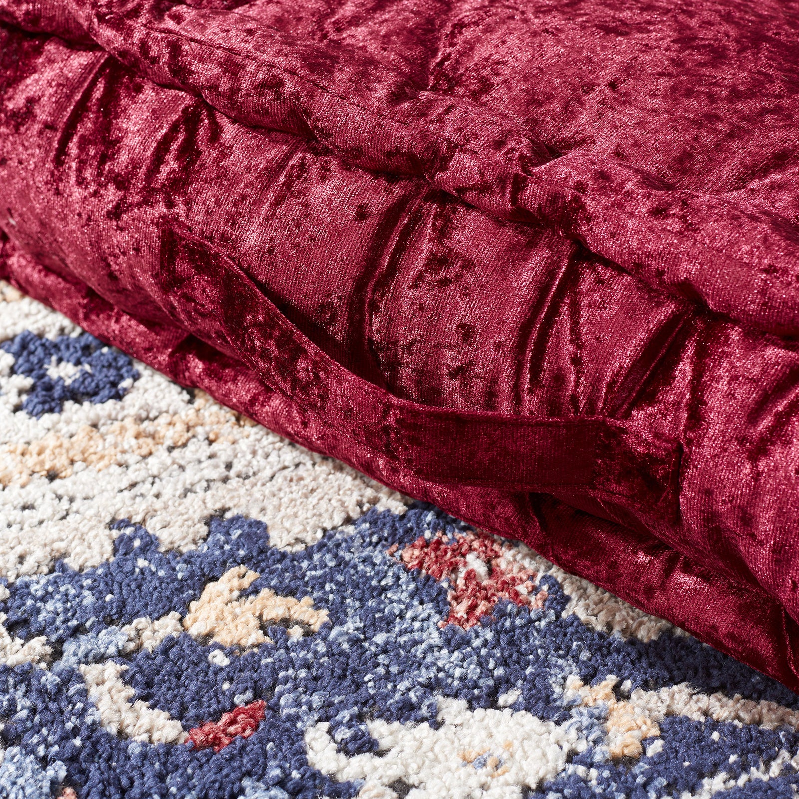 A burgundy fabric handle is sewn into the pillow's thick, velvet-like side. || FLP1001H-1818 || handle_room