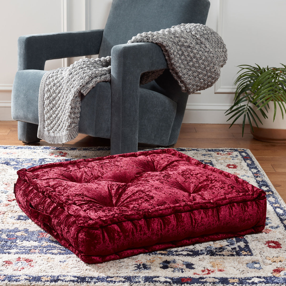 A plush burgundy floor pillow offers a low, tufted seat with inviting texture. || FLP1001H-1818 || front_angle_room