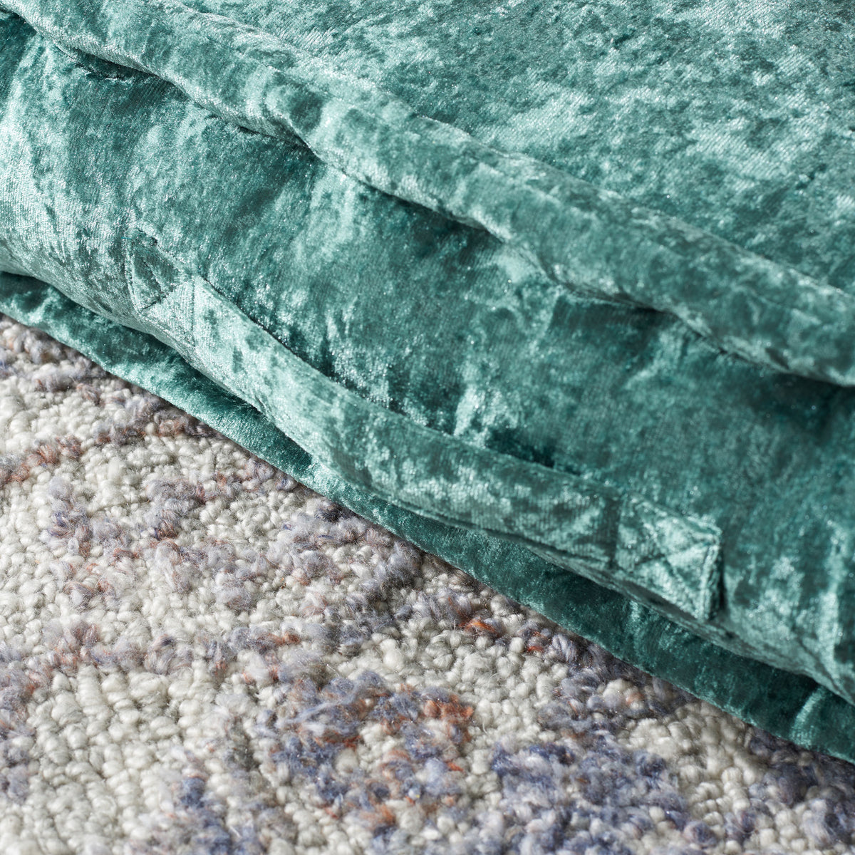 A matching green fabric handle is stitched onto the cushion's velvety side. || FLP1001J-1818 || handle_room