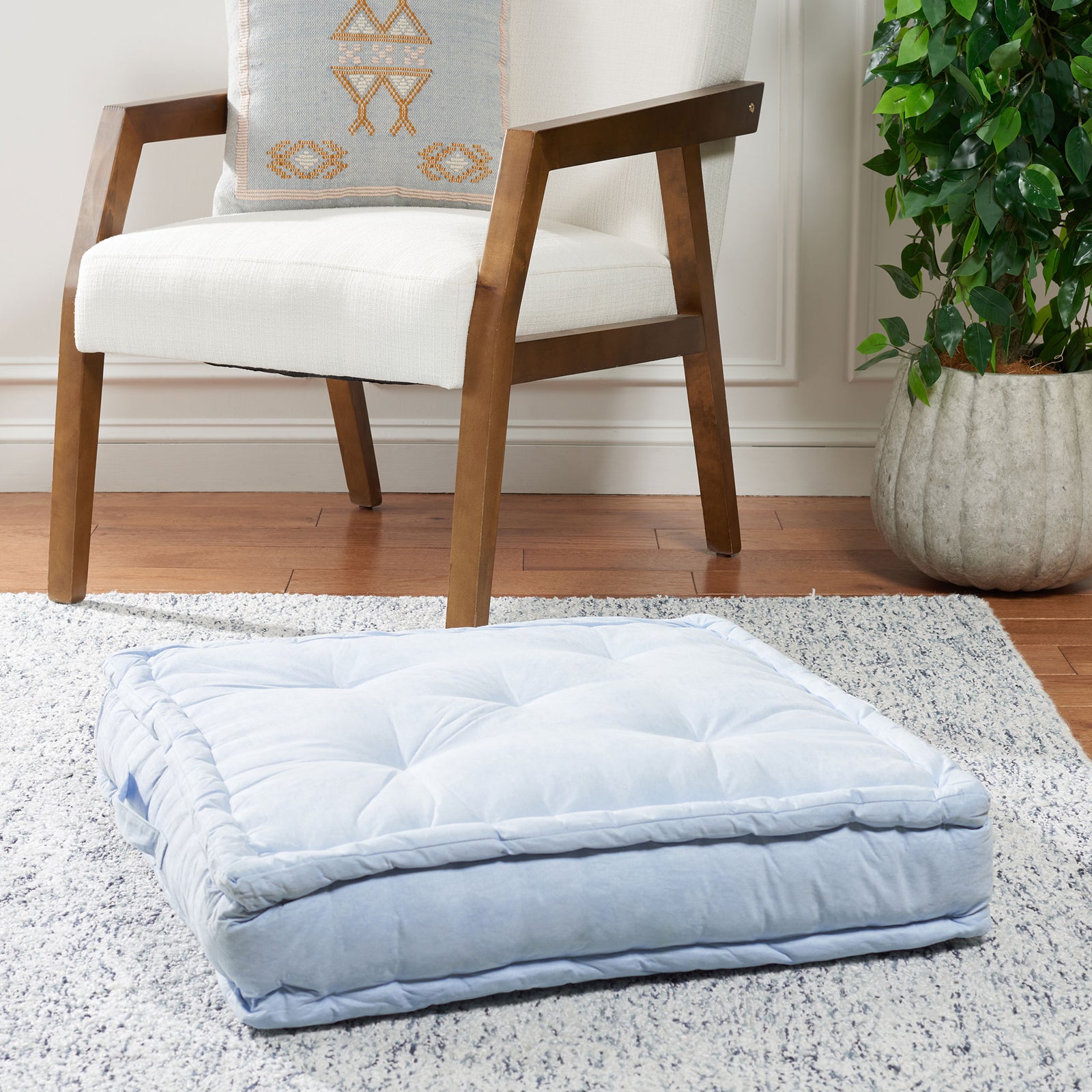 Light blue floor pillow with soft tufting and a thick padded border for comfortable floor seating || FLP1002A || front_angle_room