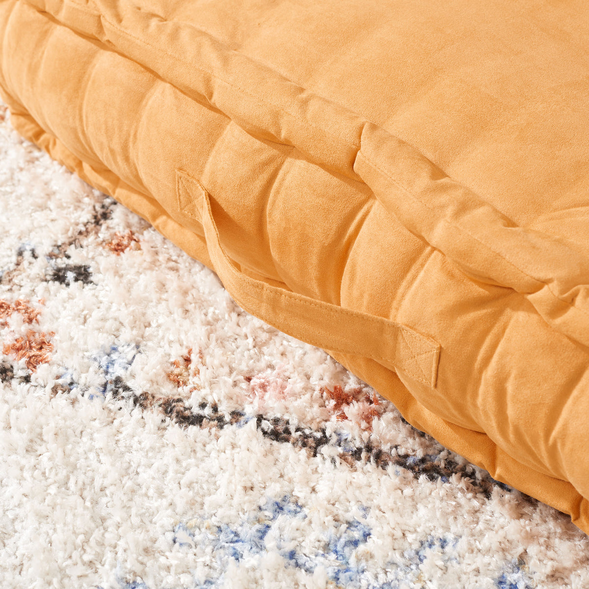 Warm ginger floor pillow with a fabric carry handle and plush, tufted sides || FLP1002C || handle_room