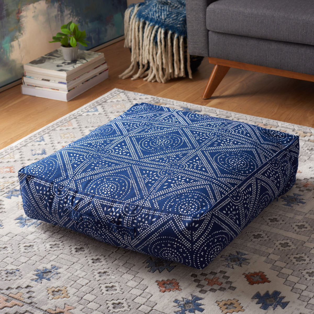Thick square floor cushion with a bold navy and white geometric pattern for lounging