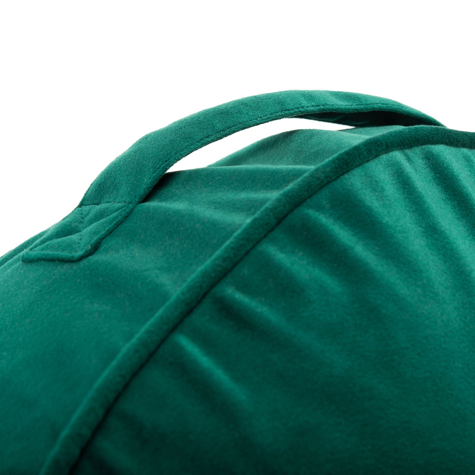 A stitched green carry strap arches over the smoothly piped side of the cushion || FLP1013A || handle_studio