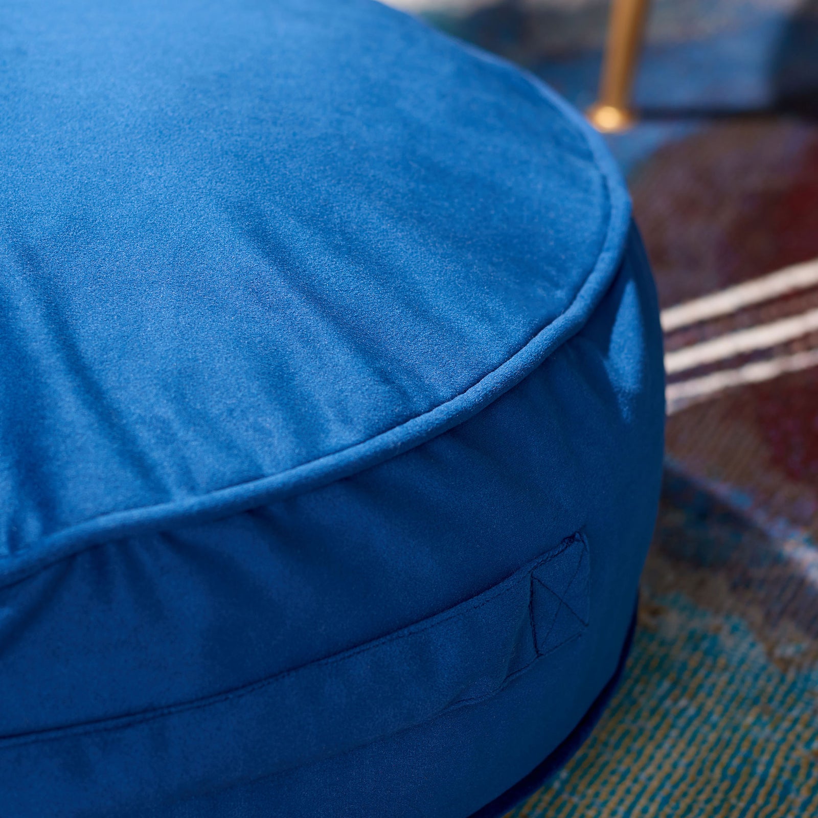 Soft royal blue fabric folds gently along the rounded, piped edge of the cushion || FLP1013C || detail_room