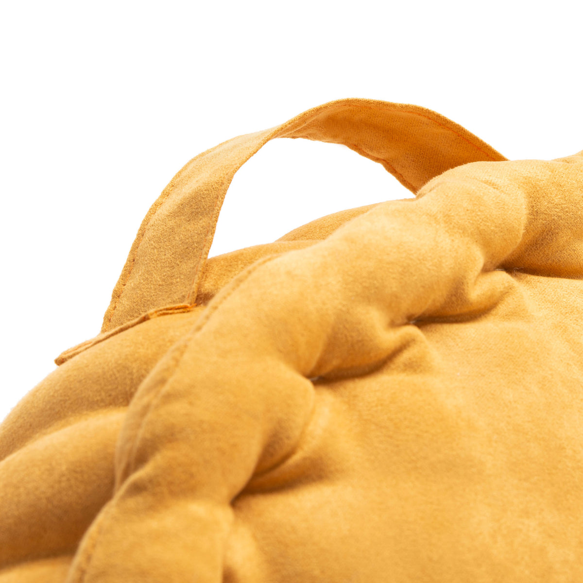 Mustard fabric carry loop sits above the pillow's pillowy, pleated border