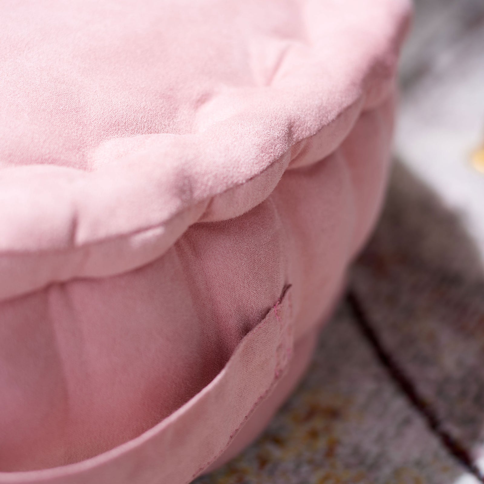Soft pink fabric and cushioned edge folds surround the pillow's sewn-on side handle || FLP1014B || detail_room