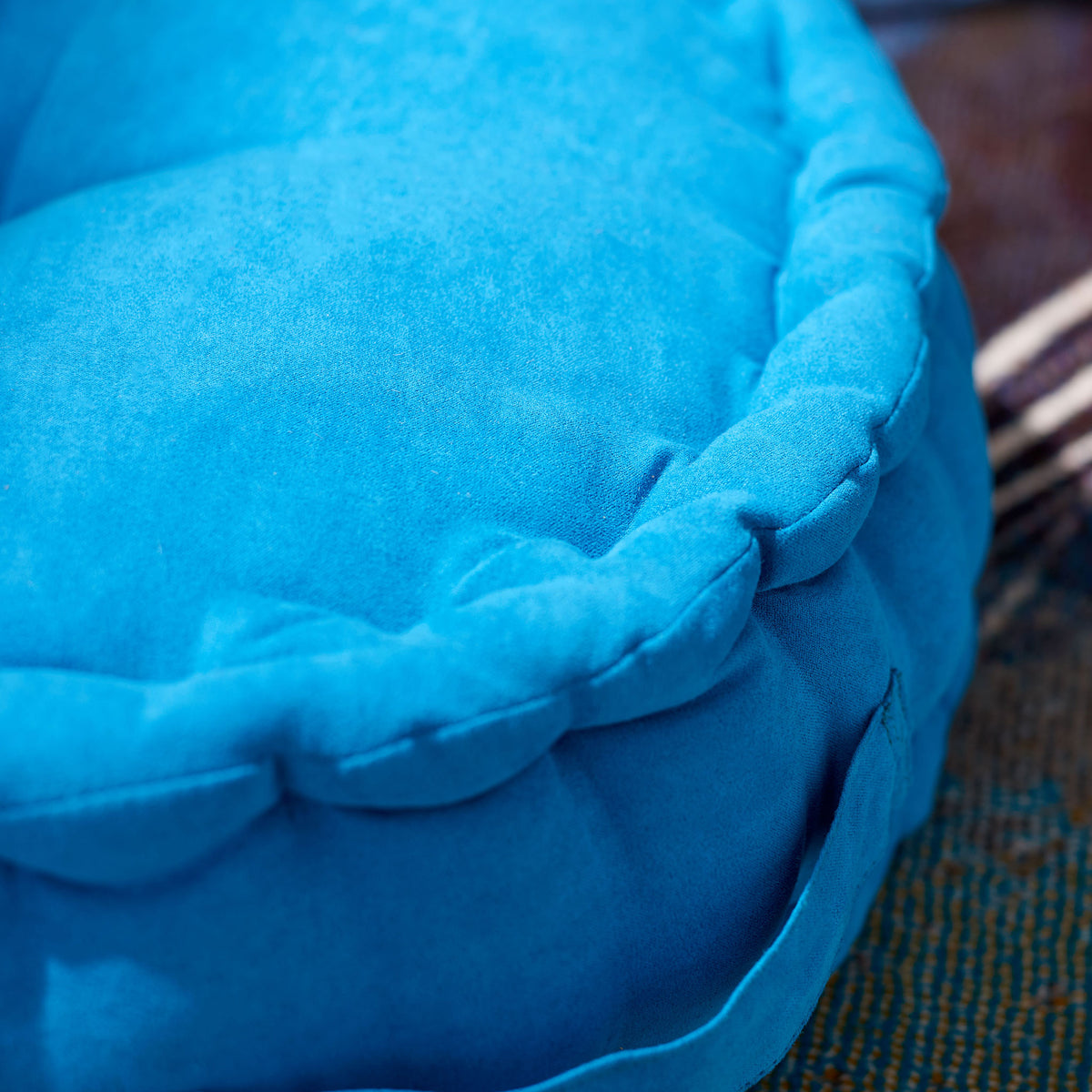 Soft blue fabric and a plump, gathered rim bring inviting texture to this floor pillow || FLP1014C || detail_room