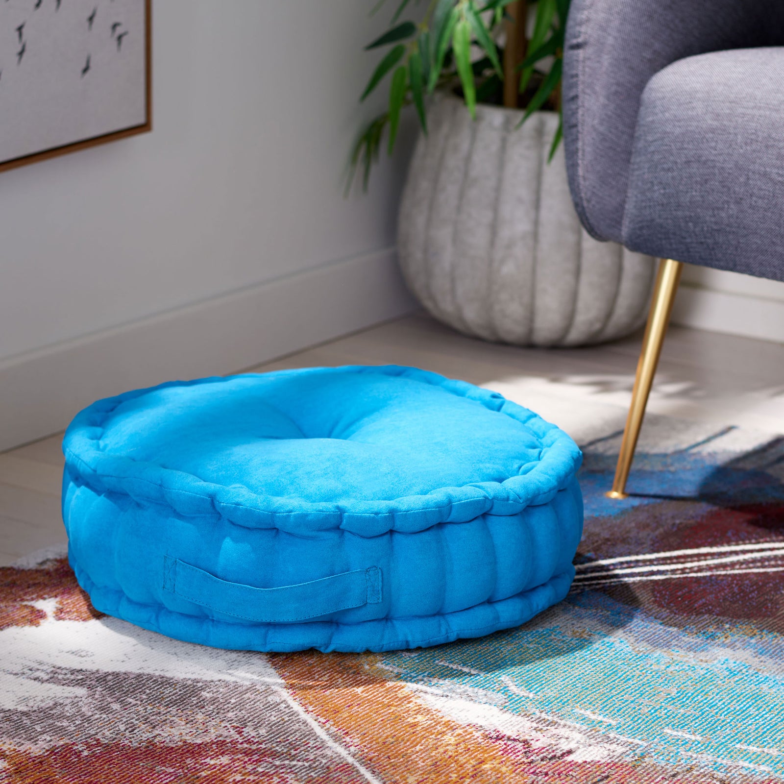 Blue floor pillow offers a plush spot to lounge, with a thick profile and easy-grip side handle || FLP1014C || front_angle_room