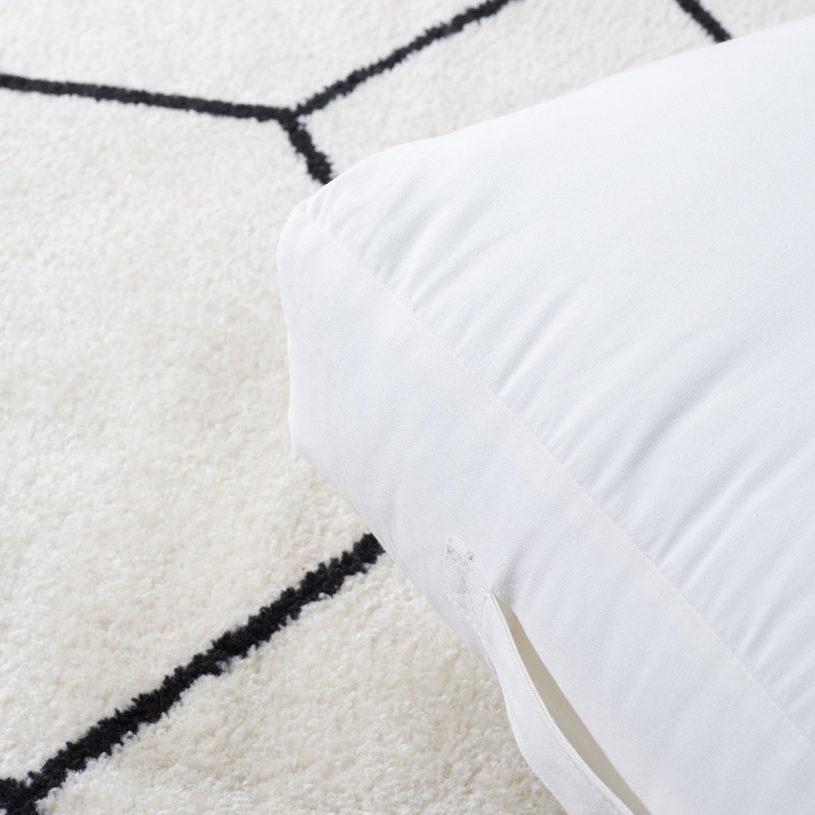 A discreet zipper and neat stitching finish the smooth fabric cover of this floor pillow. || FLP1016A || detail_room